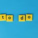 Yellow letter tiles spelling 'to do' against a vibrant blue background for organizational themes.